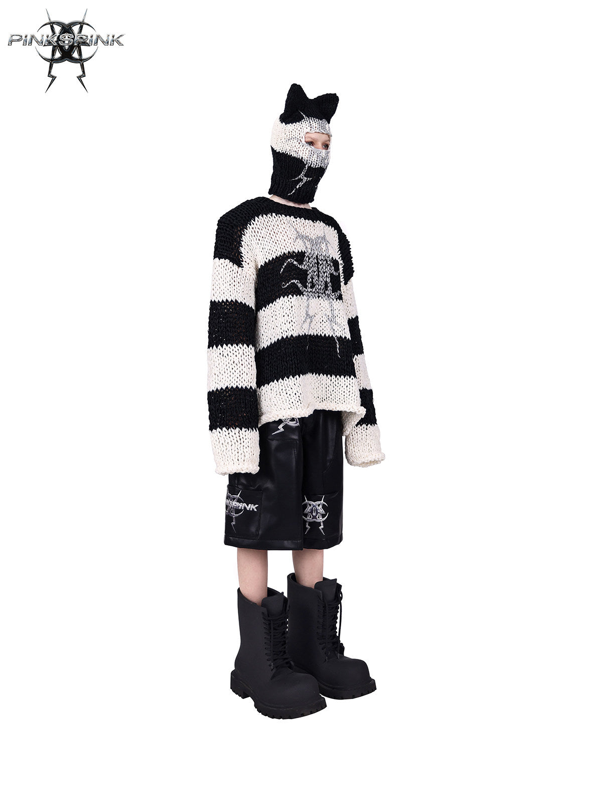 PINKSPINK MIRROR striped open-knit padded-shoulder sweater in black white stripes — angled front modeled view with the matching balaclava