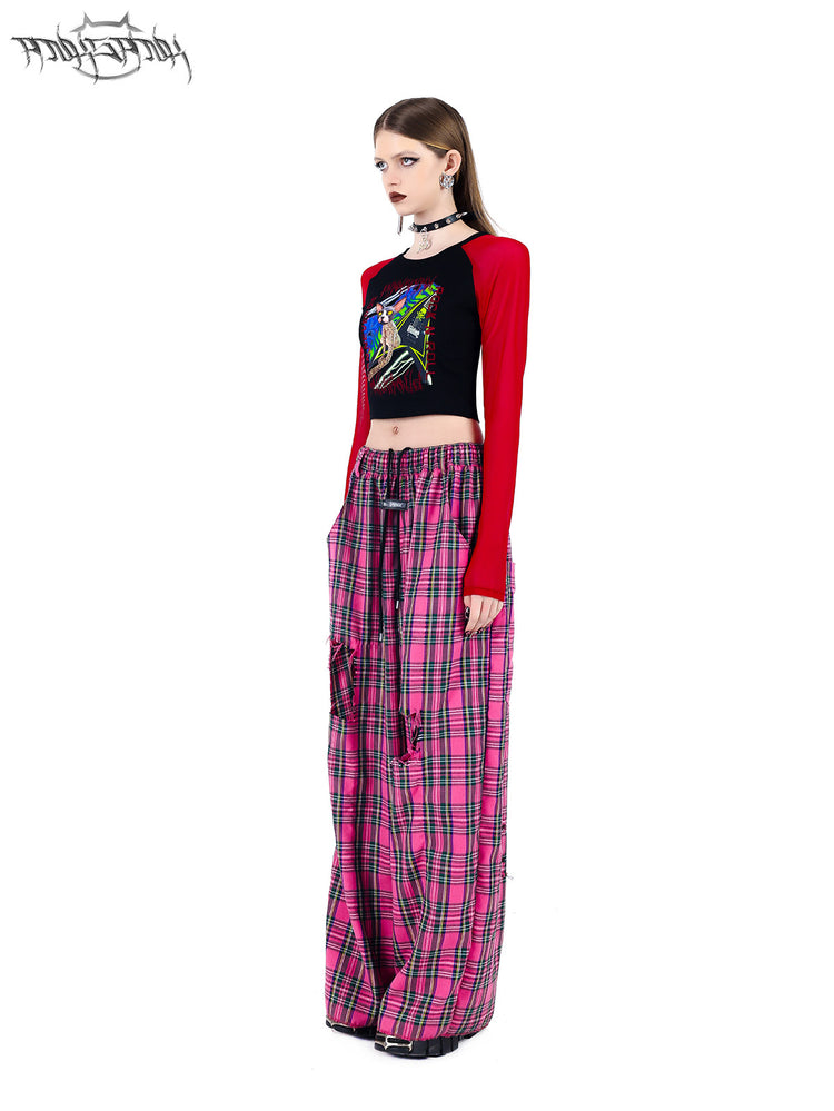 PINKSPINK PINK RIOT distressed plaid wide-leg pants — pink plaid angled view with a red raglan top