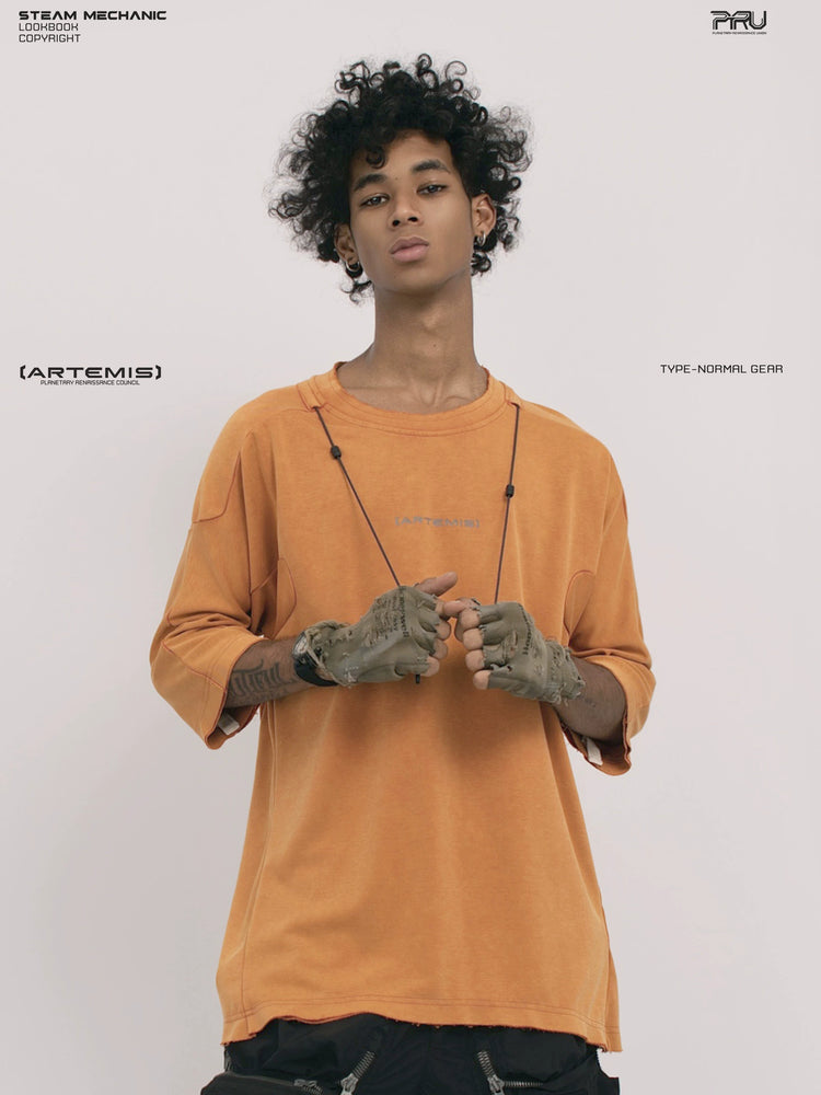 LIGHTSHADOW eclipse orange deconstructed technical tee — front three-quarter view holding the drawcords