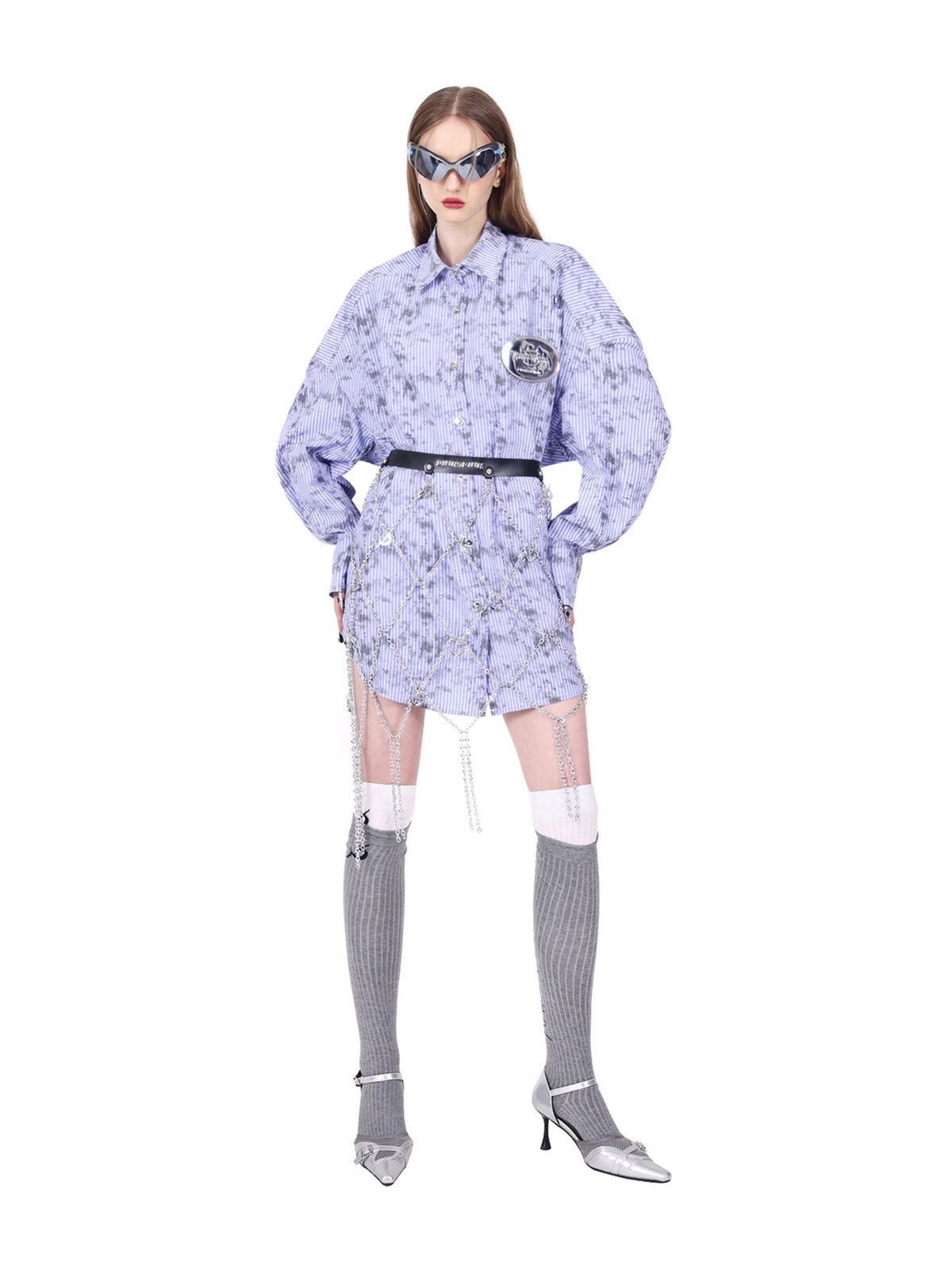 PINKSPINK ELECTRIC MOON diamond-chain belt skirt in black and silver — full-length angled front pose over a purple shirt with hands at the hips
