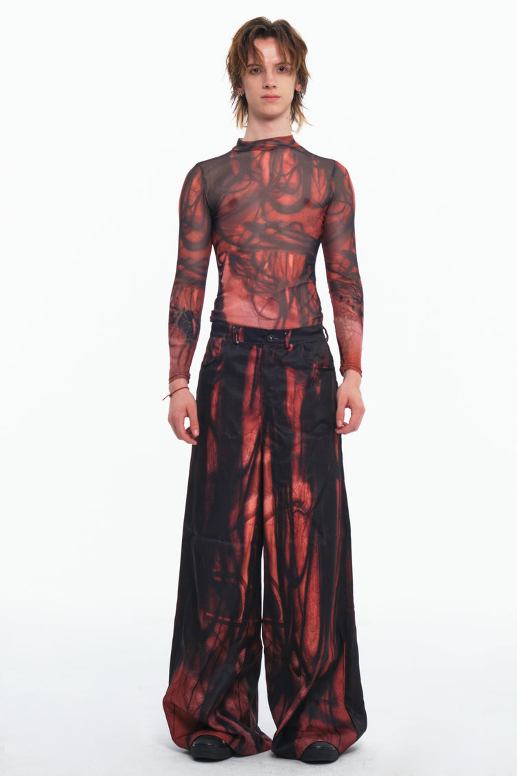 EMBRYO NERVE BLOOM printed flare pants — close modeled view