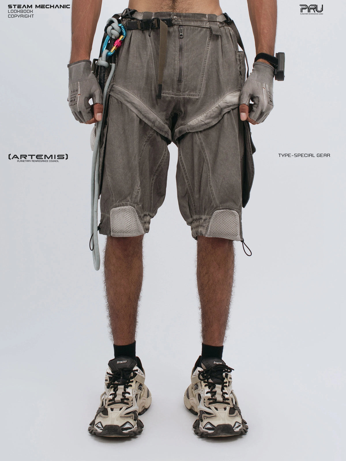 ARTEMIS xirang brown detachable technical shorts — front view with fingers hooked in the left pocket