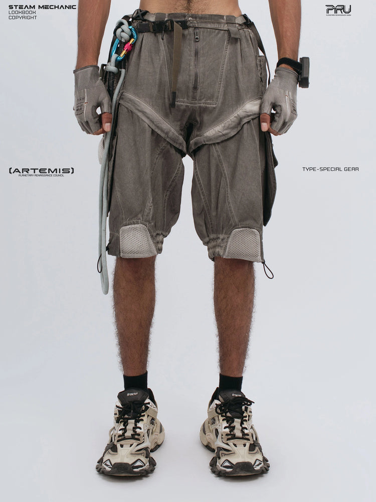 ARTEMIS xirang brown detachable technical shorts — front view with fingers hooked in the left pocket