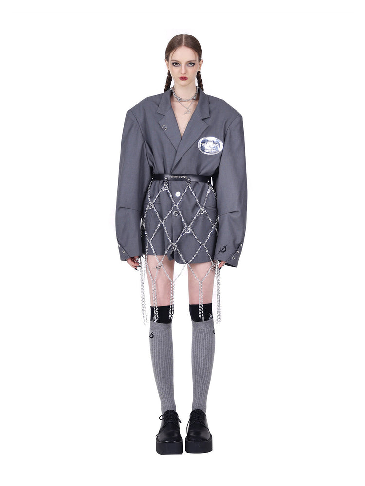 PINKSPINK REBEL pierced oversized tailored blazer in gray — full front modeled view with a separate draped chain belt