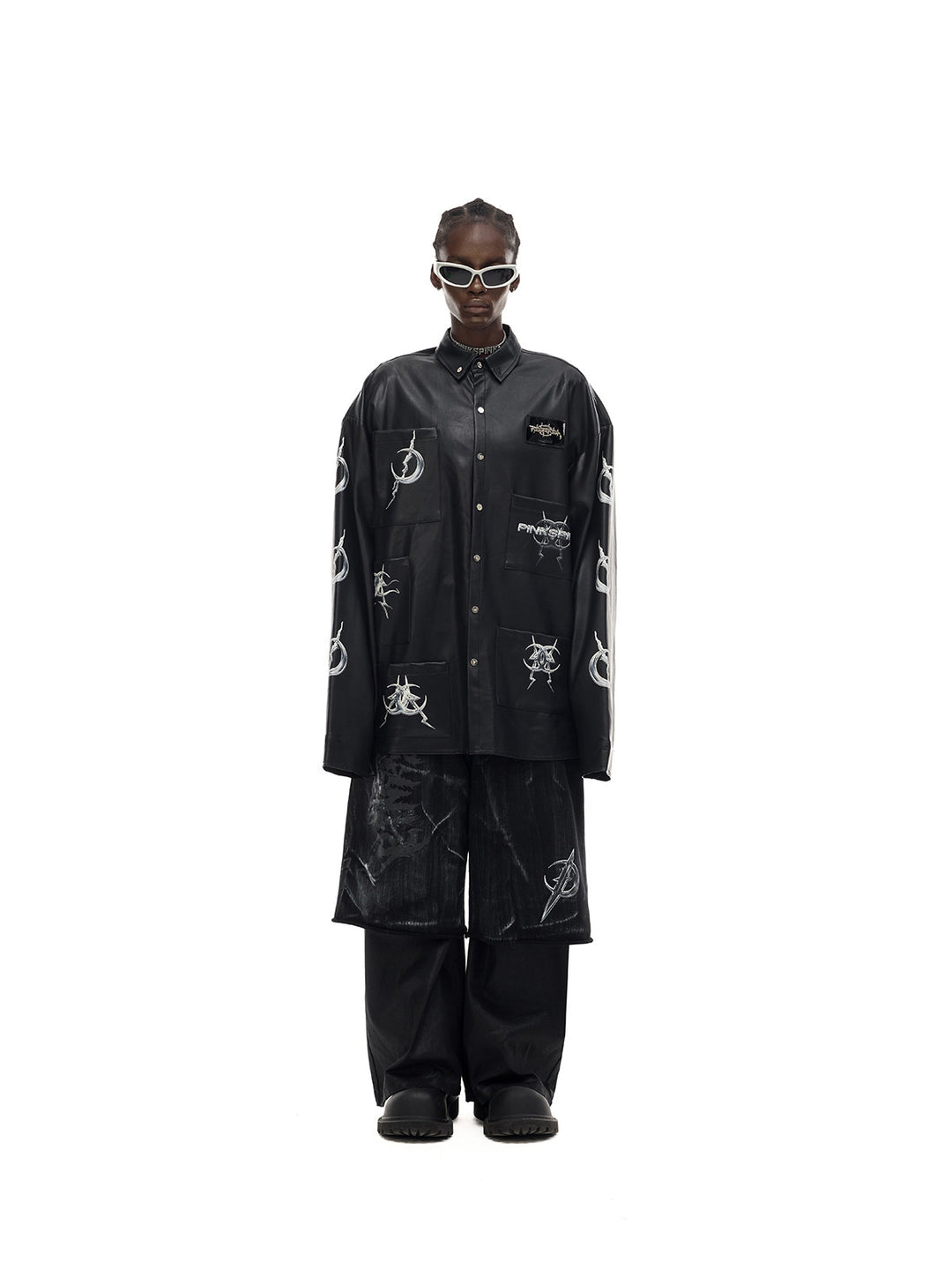 PINKSPINK ELECTRIC MOON coated zip-knee wide-leg pants in black — front styling view with a separate printed jacket and overshorts