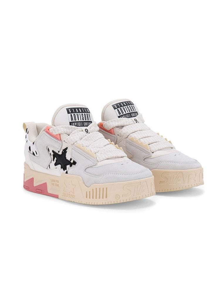 STARTER ZOO Cow Pink sneakers in a clean three-quarter studio pair view, showing cow-print star panels, broad white laces and pink heel accents