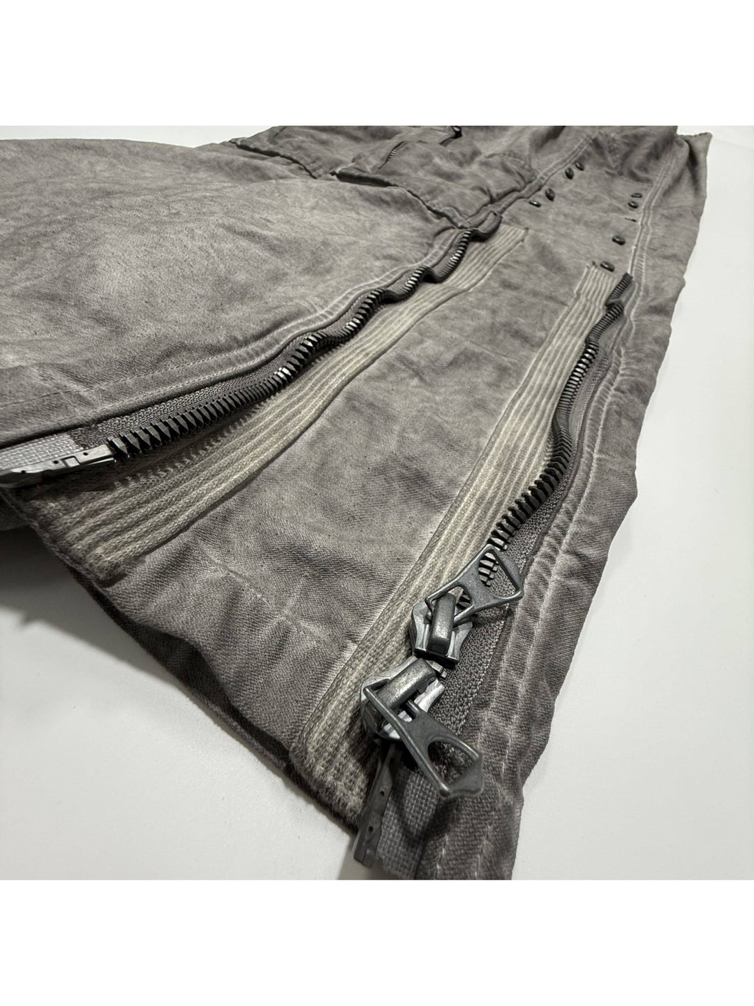 PIONEER meteor gray knee-mesh utility work pants — opened lower-leg zippers showing silhouette adjustment