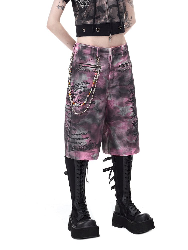 PINKSPINK ELECTRIC MOON coated camouflage denim shorts in pink-gray camouflage — close angled front view styled with separate decorative chains