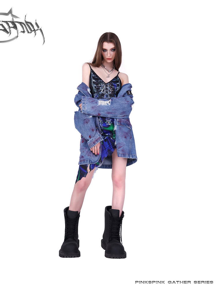 PINKSPINK COSMOS skeleton-print asymmetric slip dress in blue green multicolor — front modeled view styled with a jacket draped off the shoulders