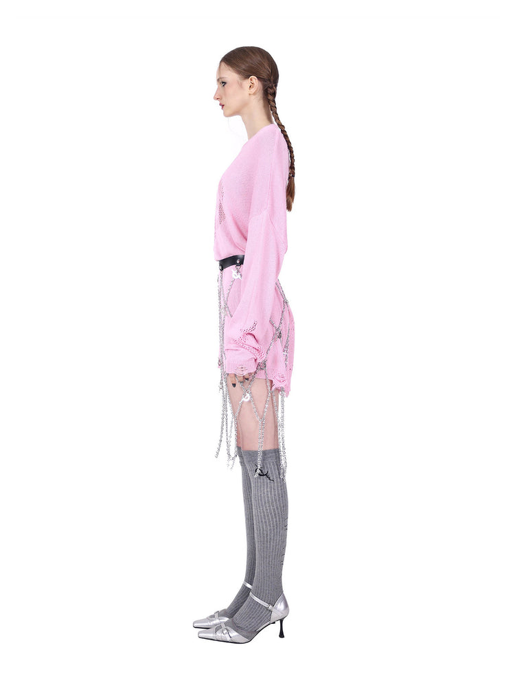 PINKSPINK ELECTRIC MOON distressed open-knit sweater in pink — full-length side view with a separate belt and chain layer