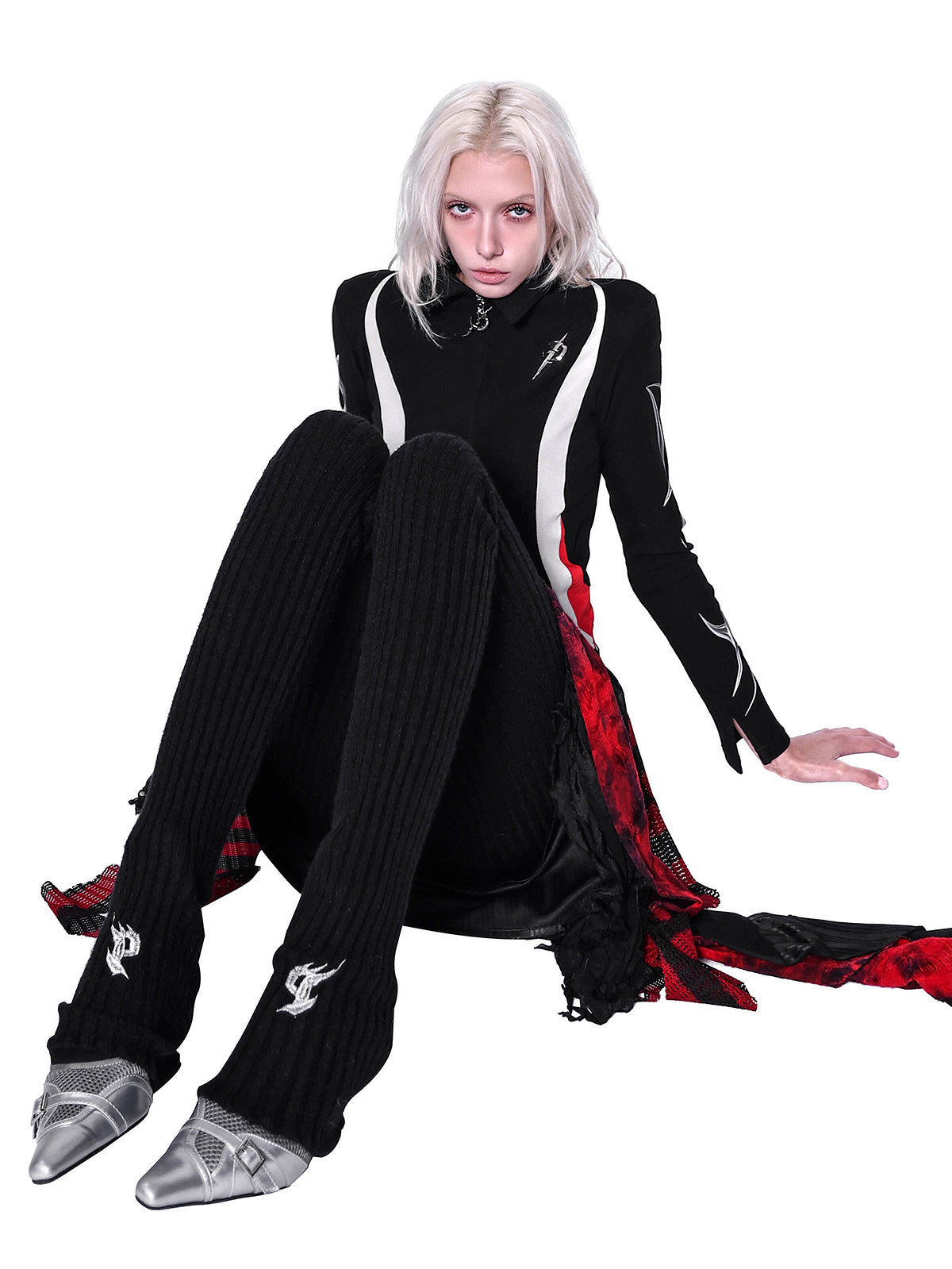 PINKSPINK ELECTRIC MOON layered striped mesh mini skirt — black and red — seated modeled view showing the draped side panels