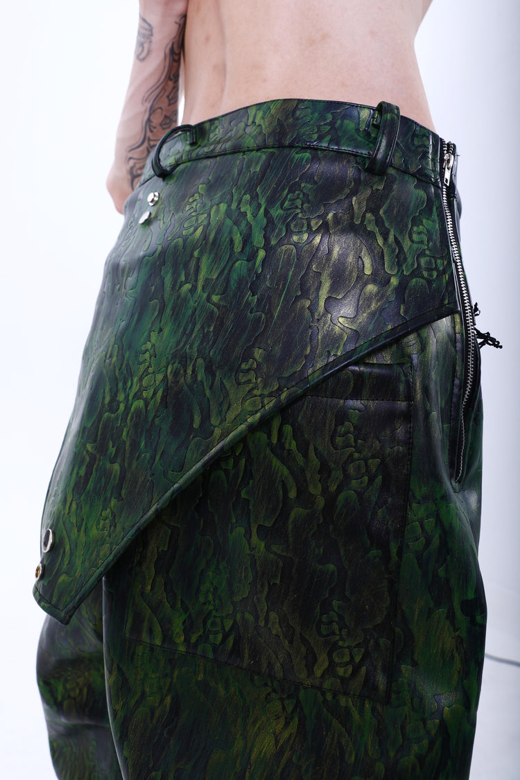 EMBRYO TRIANGLE ARMOR lace-inset leather pants in green — rear three-quarter hip detail showing the patch pocket