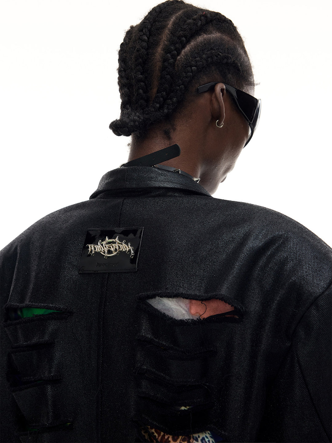 PINKSPINK BREACH distressed coated oversized blazer in black — close-up of the upper back label, coating texture and torn openings