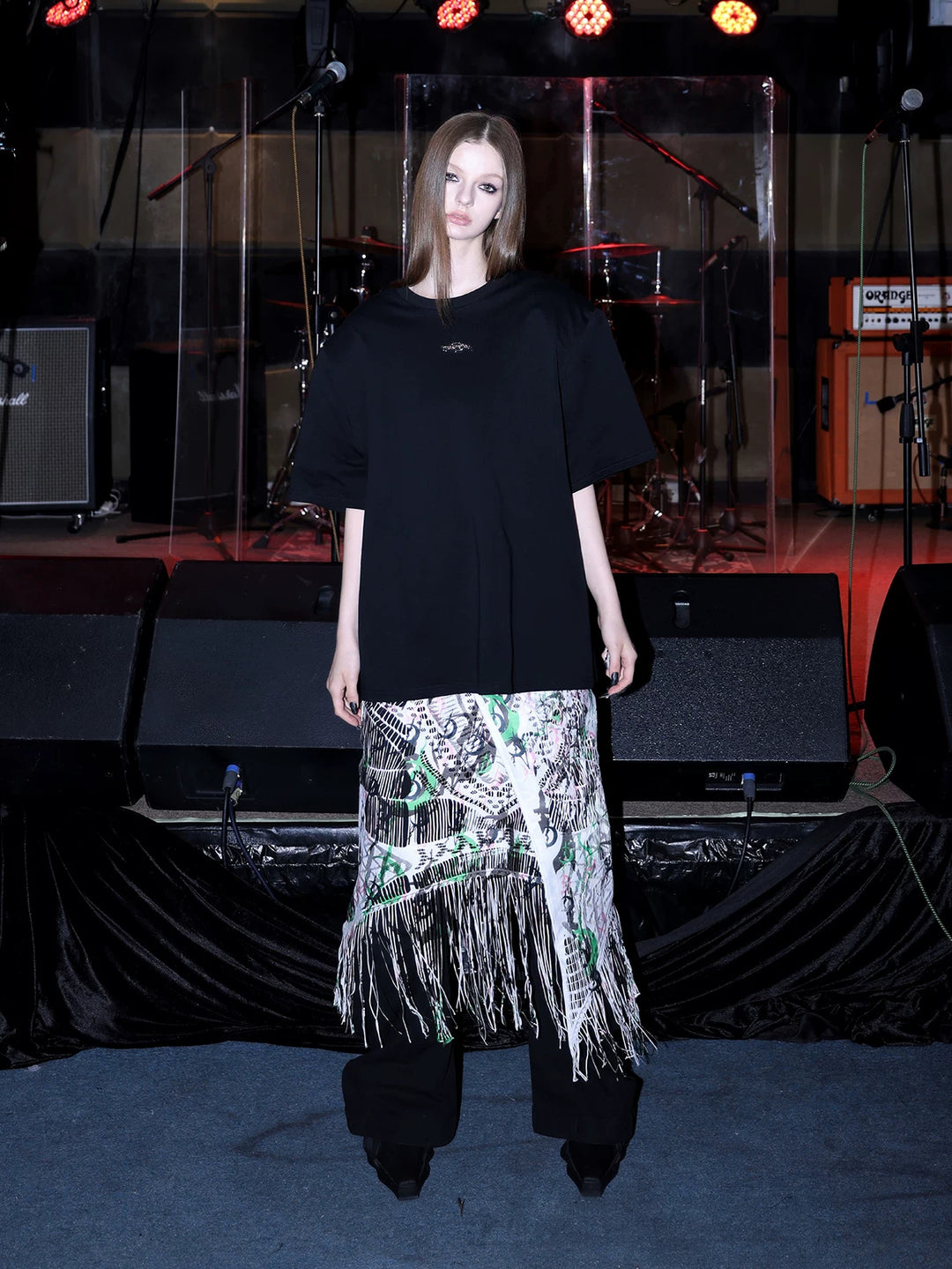 PINKSPINK SHRED SIGNAL printed fringe layering apron — white multicolor — front view layered over black trousers