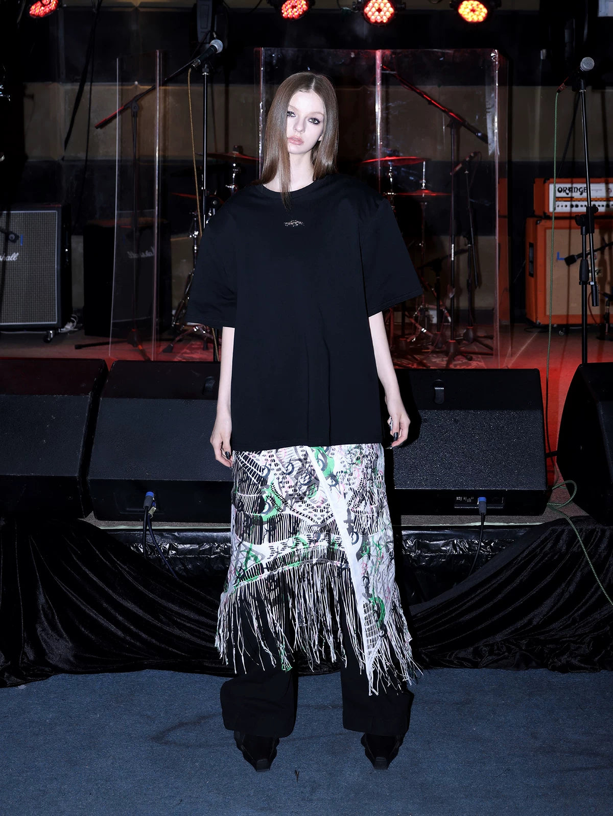 PINKSPINK SHRED SIGNAL printed fringe layering apron — white multicolor — front view layered over black trousers