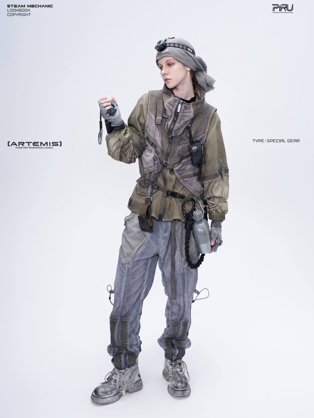 FISSION modular vest — mercury brown full-length modeled view holding a radio away from the face