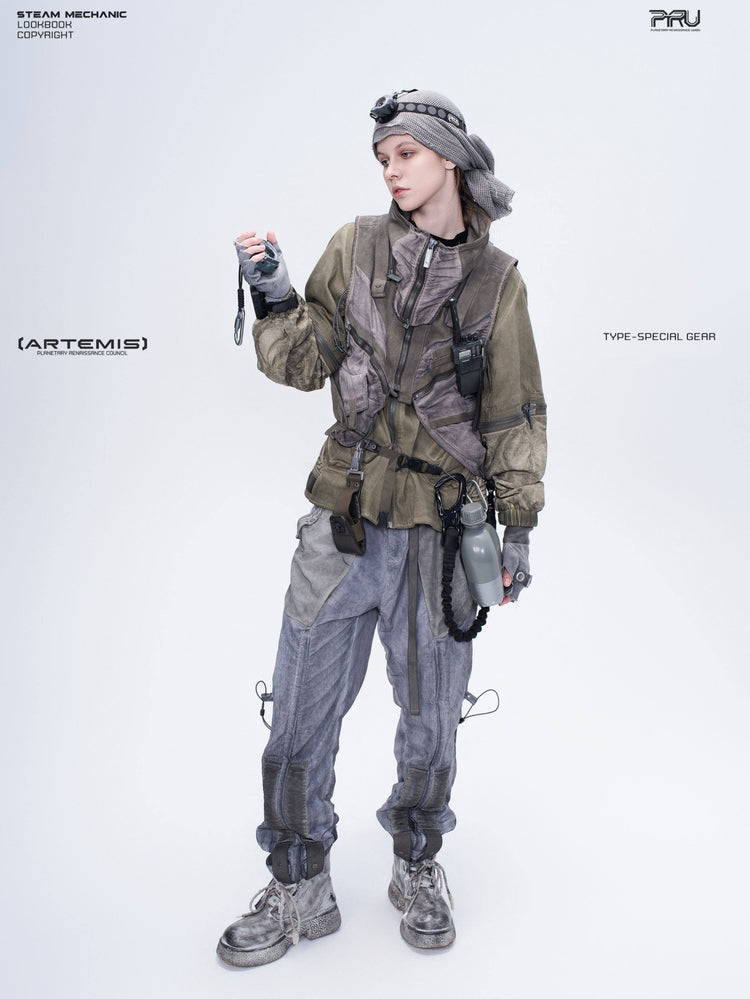 FISSION modular vest — mercury brown full-length modeled view holding a radio away from the face