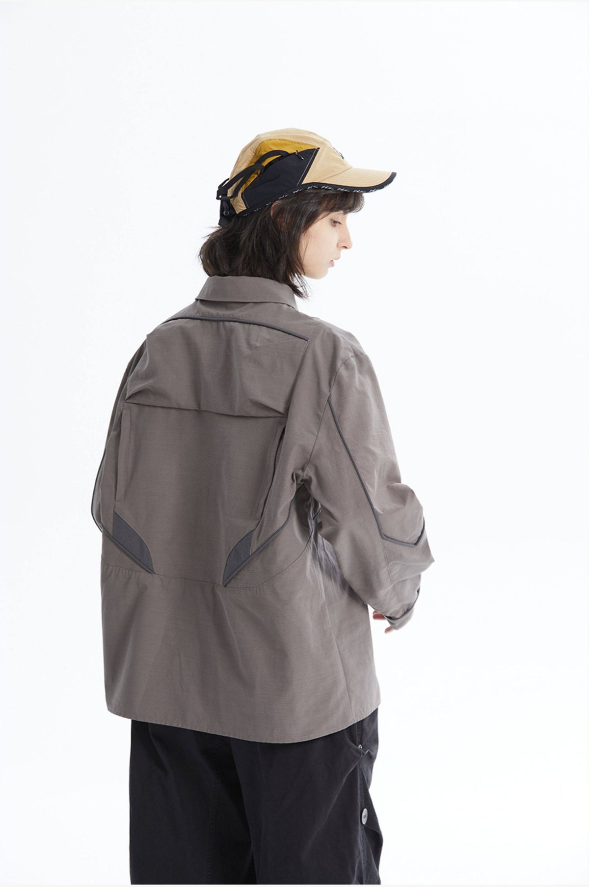 ERRORCODE ROBOT taupe tech work shirt — back three-quarter modeled view with cap; source gallery image 2