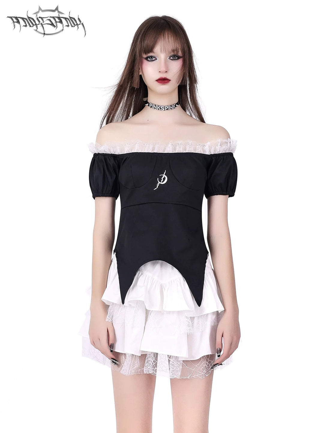 PINKSPINK BUTTERFLY EFFECT off-shoulder two-piece mini dress in black white — front modeled close-up showing the pointed black top and tiered white skirt