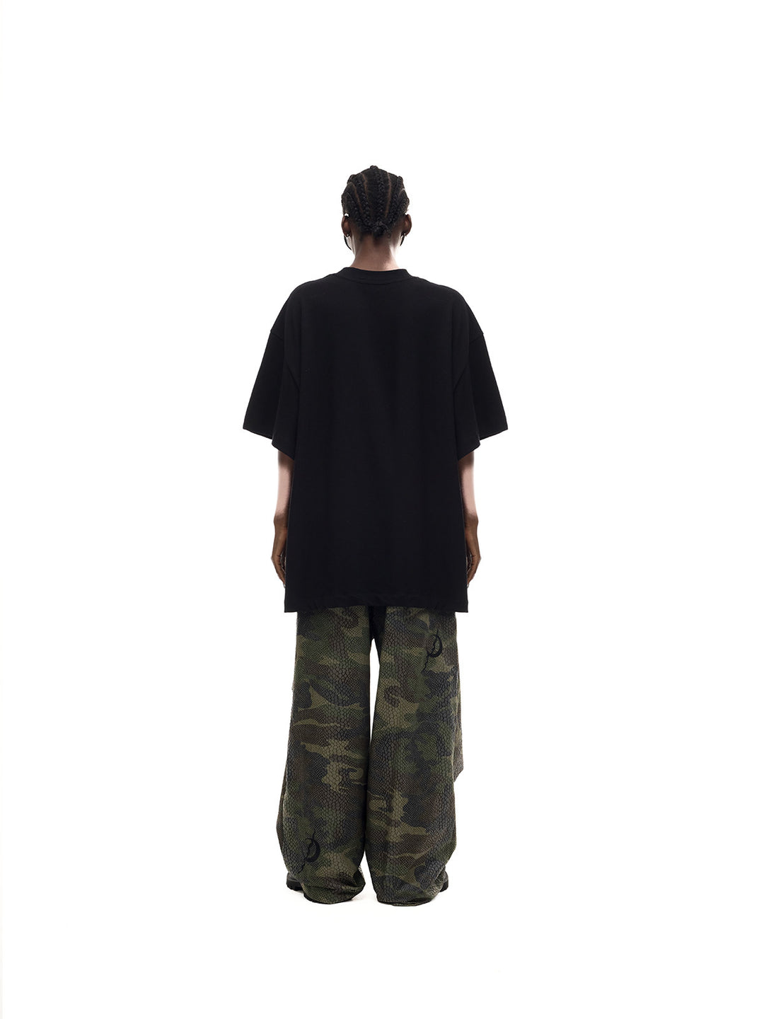 PINKSPINK MONSTER cat-skeleton oversized graphic tee in black — full-length rear modeled view showing the plain back and dropped shoulders