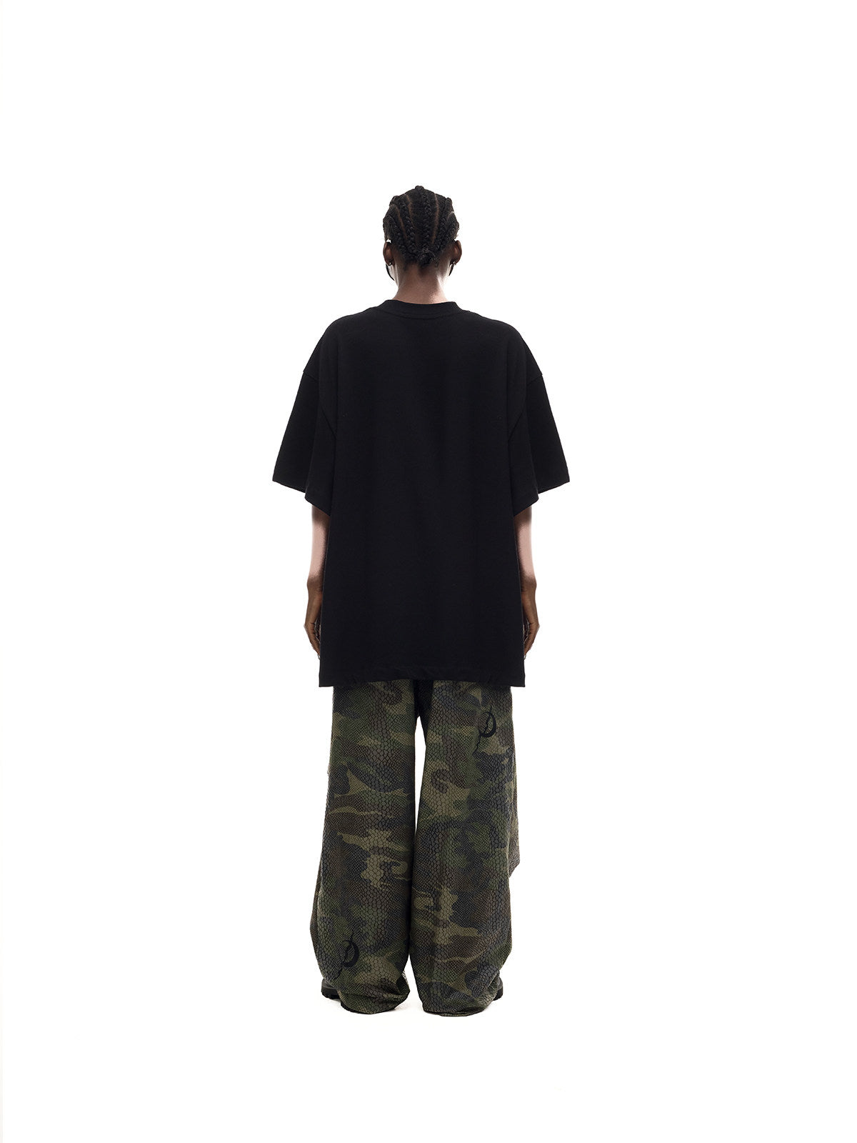 PINKSPINK MONSTER cat-skeleton oversized graphic tee in black — full-length rear modeled view showing the plain back and dropped shoulders