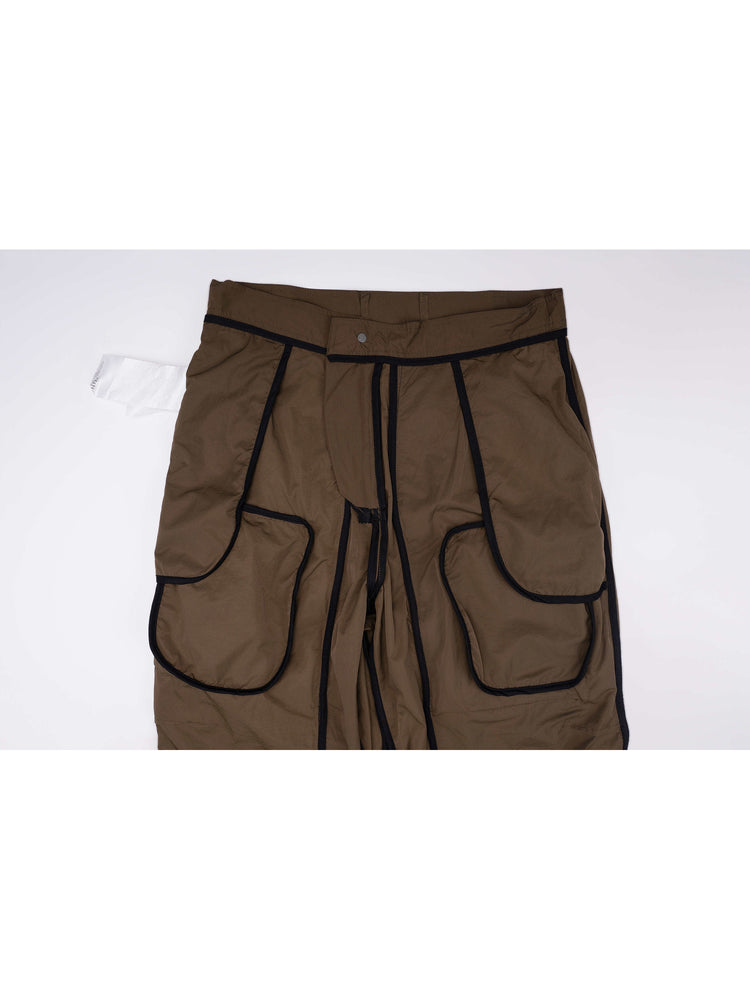 GAIA curved-blade technical pants in mountain green — interior construction detail showing bound seams and pocket bags