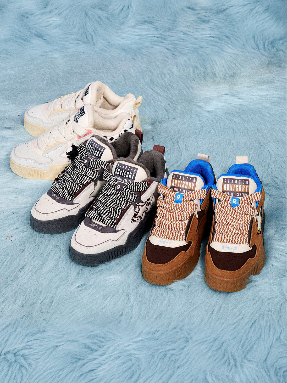STARTER ZOO Cow Pink pair at the back left in a ZOO series group arrangement; gray and brown sneakers are separate designs