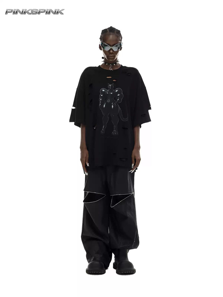 PINKSPINK ELECTRIC MOON coated zip-knee wide-leg pants in black — front full-length modeled view styled with a graphic tee