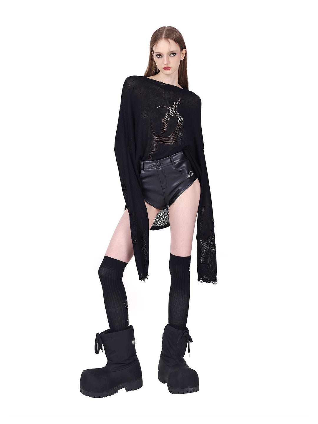 PINKSPINK REBEL ring-pierced faux-leather hotpants in black — angled modeled view showing the smooth faux-leather finish
