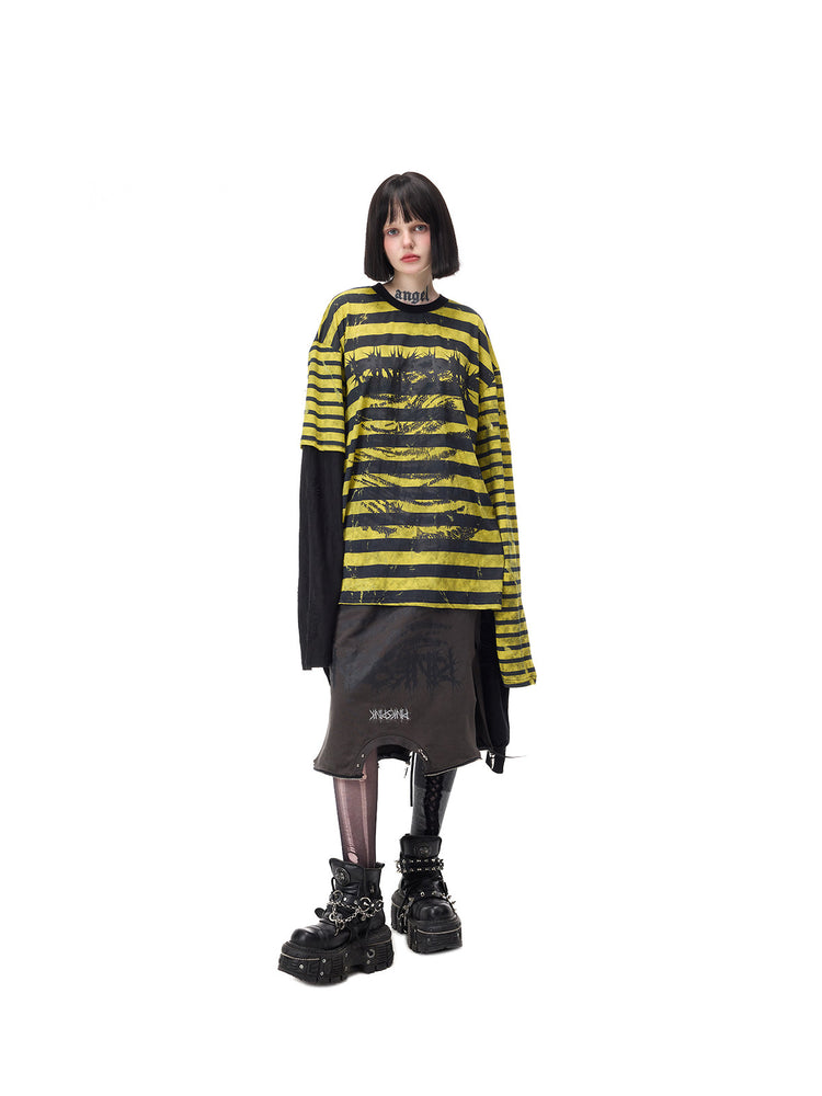 PINKSPINK STATIC asymmetric striped burnout long-sleeve tee in black and yellow — centered full-length front modeled view over a separate dark skirt