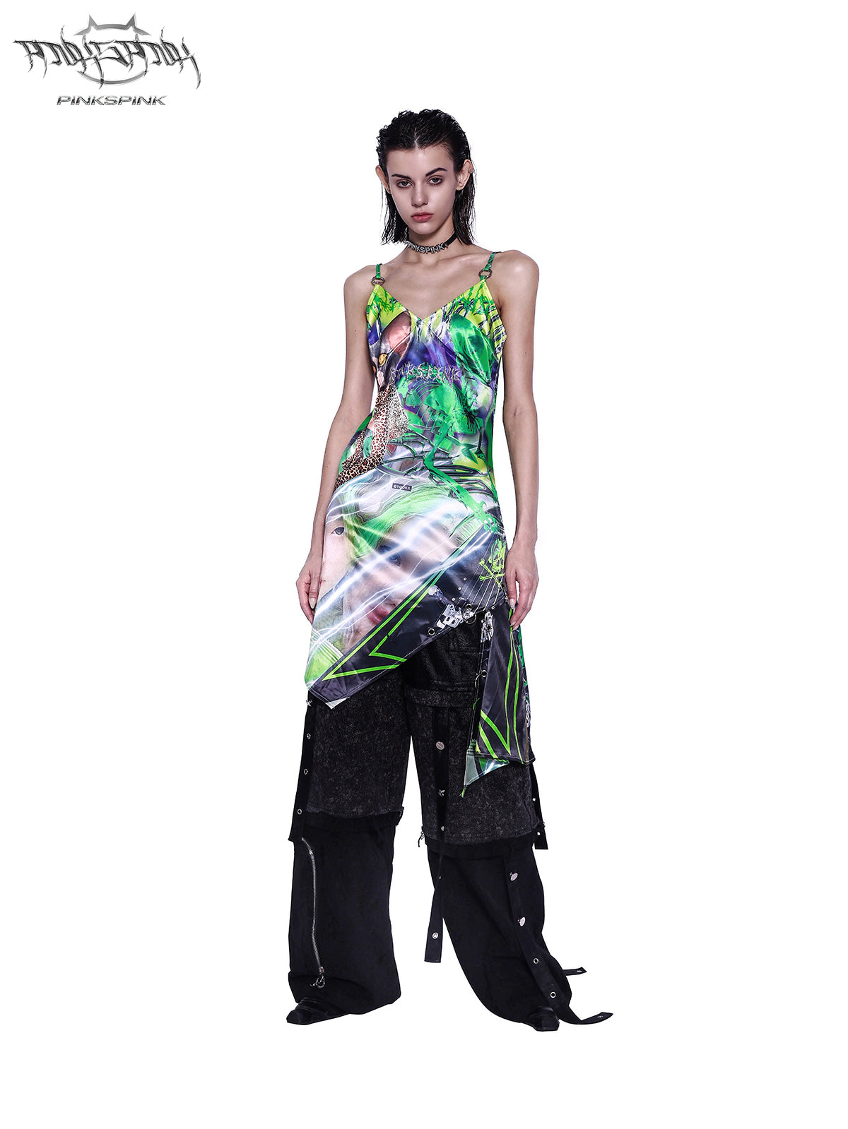 PINKSPINK RECOMBINATION stacked low-rise jeans in black — front view layered beneath a green printed slip dress.
