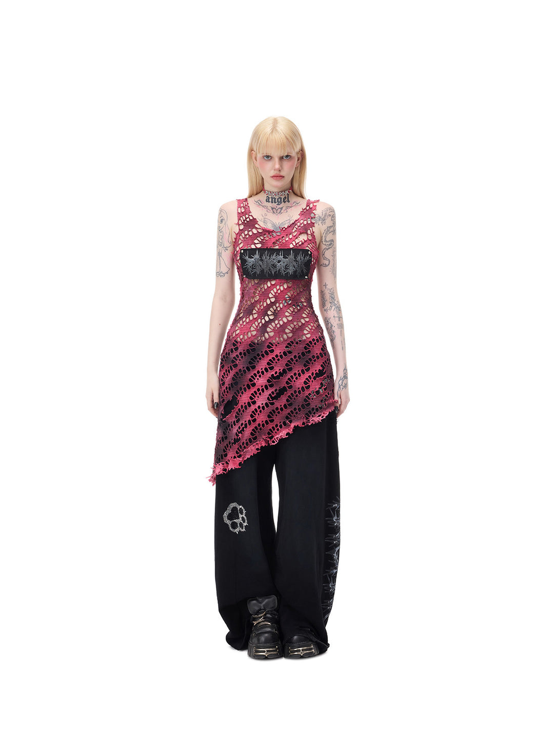 PINKSPINK AFTERGLOW distressed open-knit asymmetric dress in hot pink — centered full-length front modeled view with separate black wide-leg trousers
