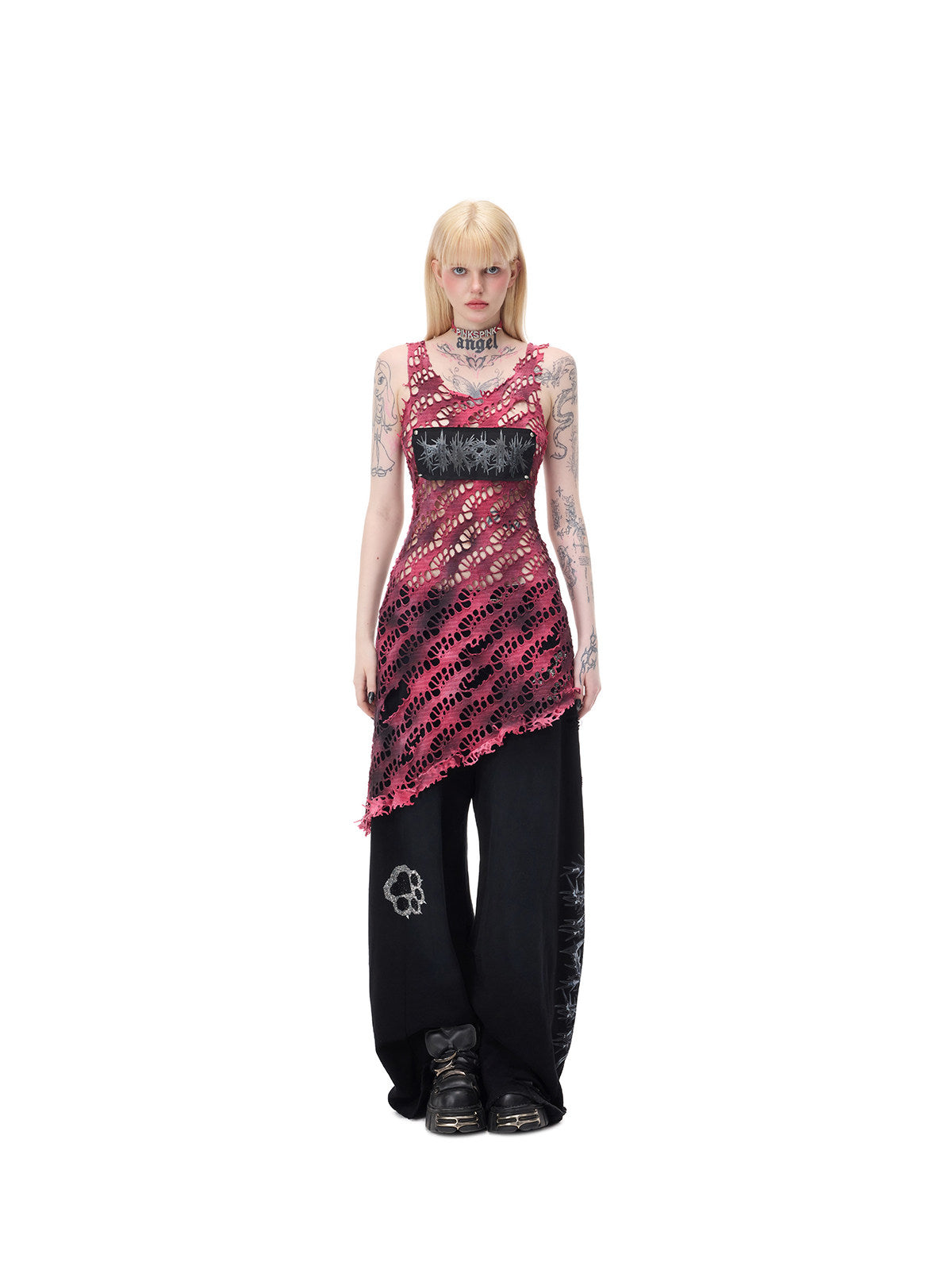 PINKSPINK AFTERGLOW distressed open-knit asymmetric dress in hot pink — centered full-length front modeled view with separate black wide-leg trousers