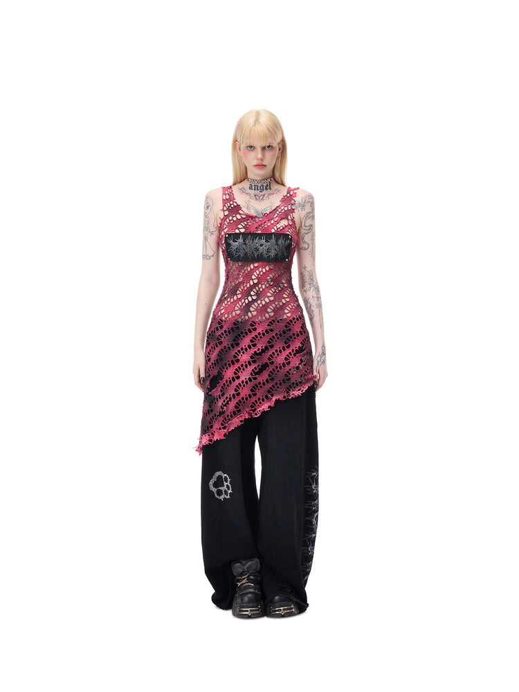 PINKSPINK AFTERGLOW distressed open-knit asymmetric dress in hot pink — centered full-length front modeled view with separate black wide-leg trousers
