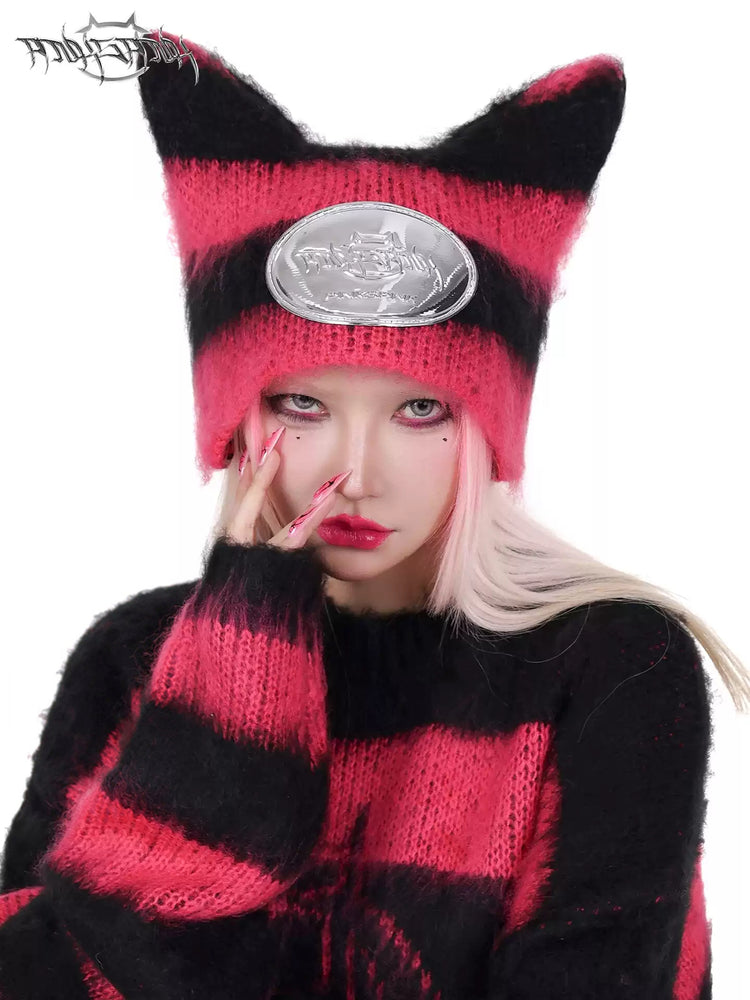 PINKSPINK SPHYNX striped cat-ear knit hat in black pink — front modeled close-up showing the pointed ears and silver-tone badge