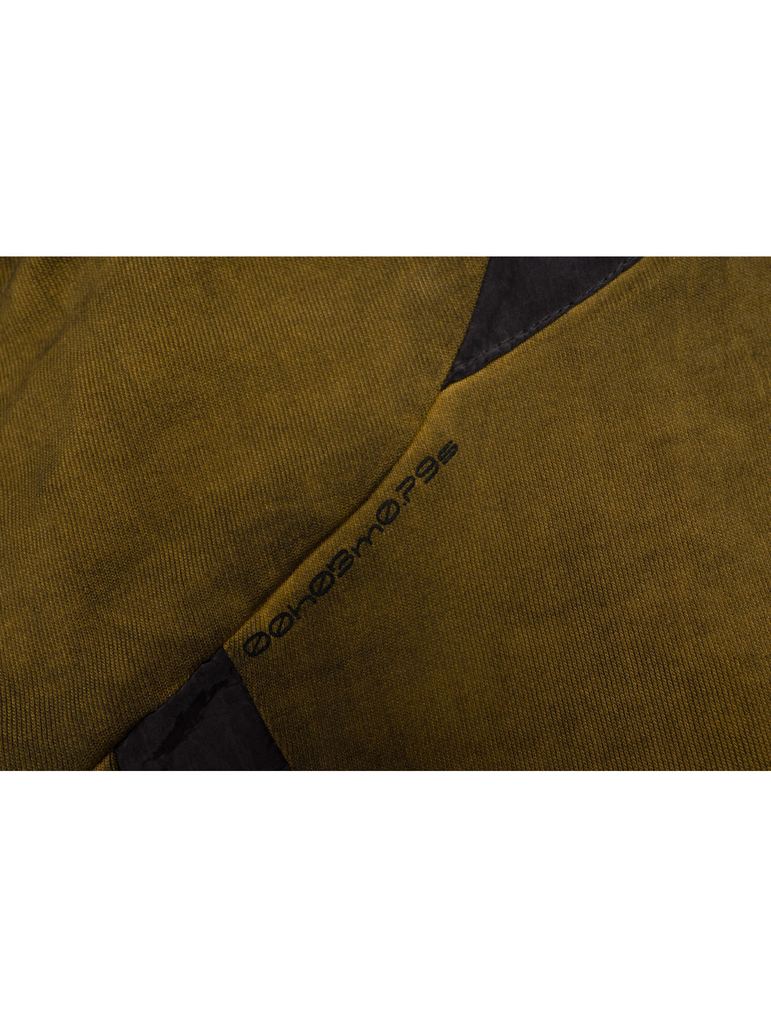 PIONEER mars yellow drawstring commuter sweatshirt — close-up of the sleeve panel seam and small printed garment marking