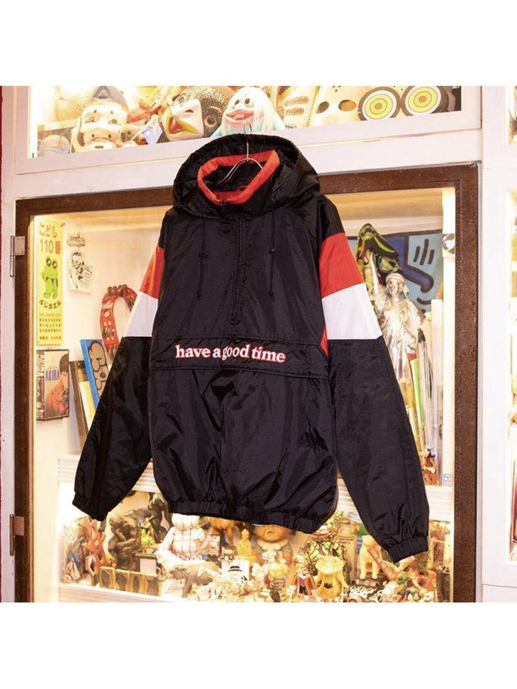 HAVE A GOOD TIME ANORAK padded jacket hanging in a display window, showing its hood and front pocket
