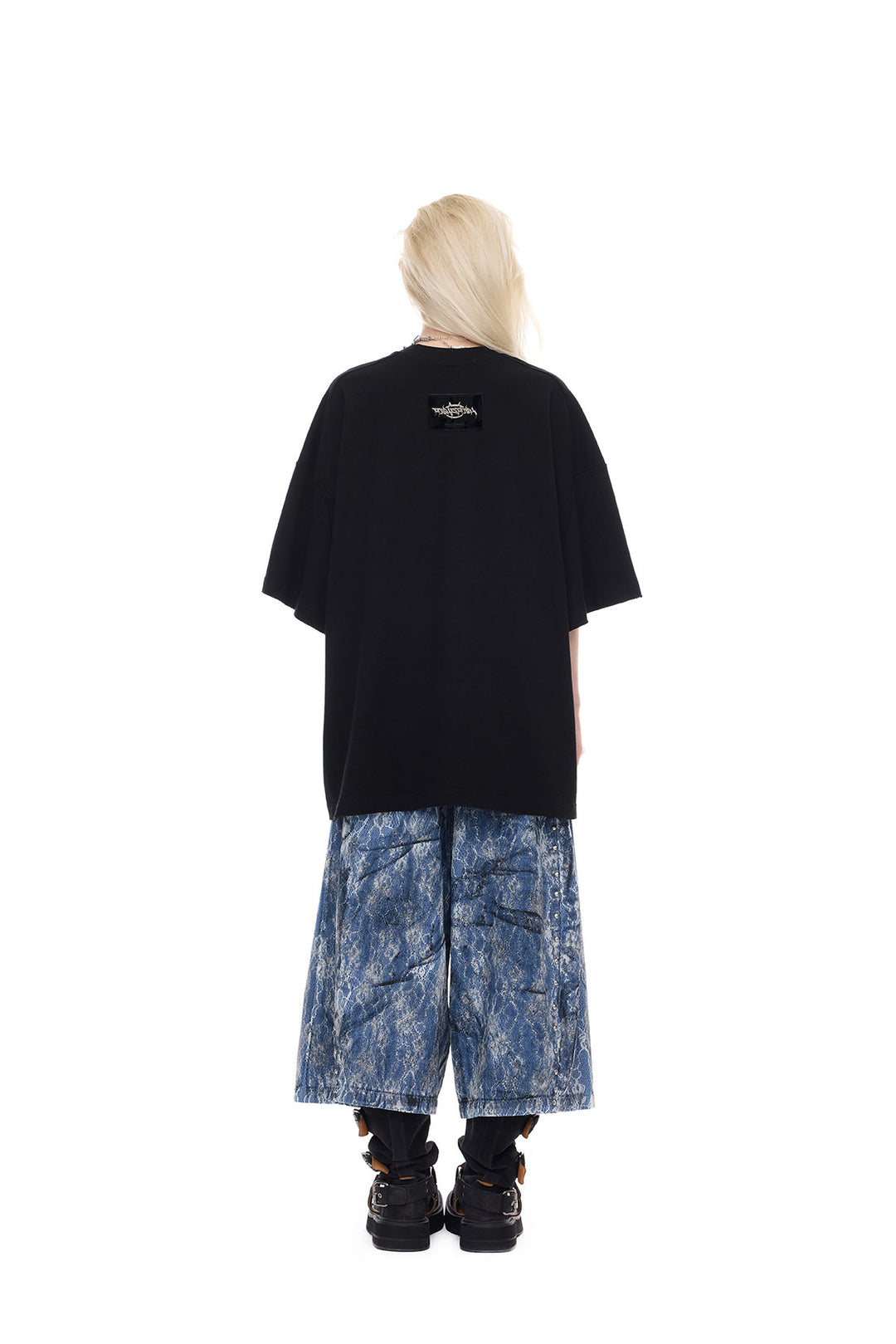 PINKSPINK ELECTRIC MOON lace-coated wide-leg denim shorts in blue — full-length back modeled view with a plain black tee