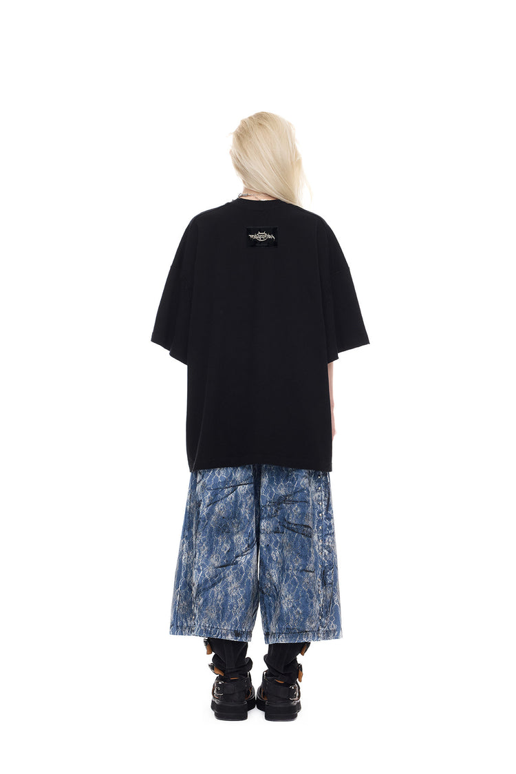 PINKSPINK ELECTRIC MOON lace-coated wide-leg denim shorts in blue — full-length back modeled view with a plain black tee