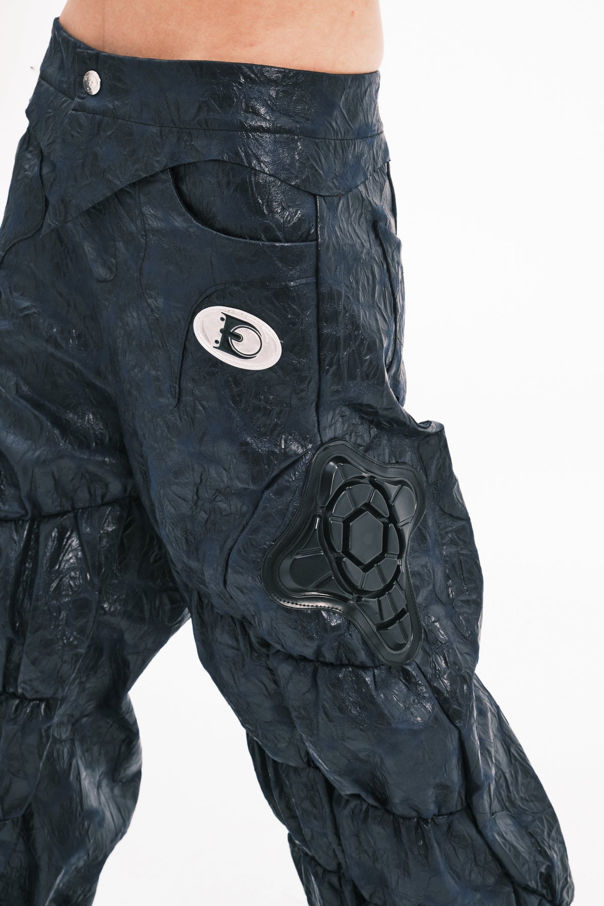 EMBRYO GUARD SHELL ruched PU leather flare pants — material and hardware detail