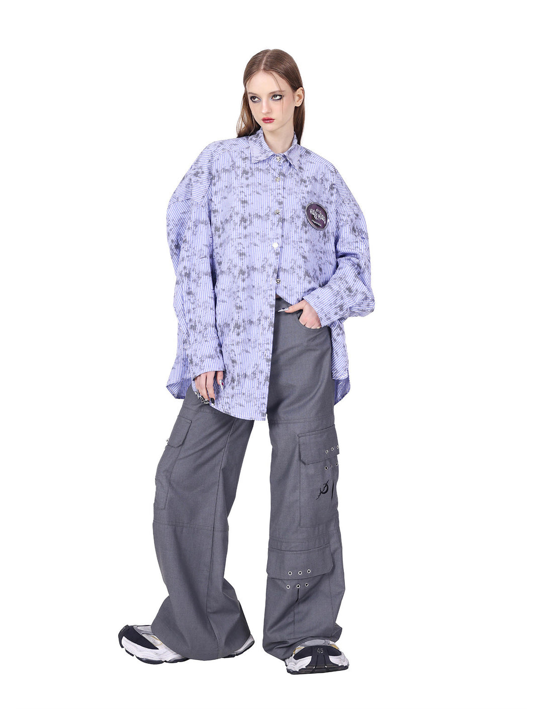 PINKSPINK ELECTRIC MOON ring-detail cargo flare trousers in gray — angled full-length view showing the wide flared silhouette with a separate shirt