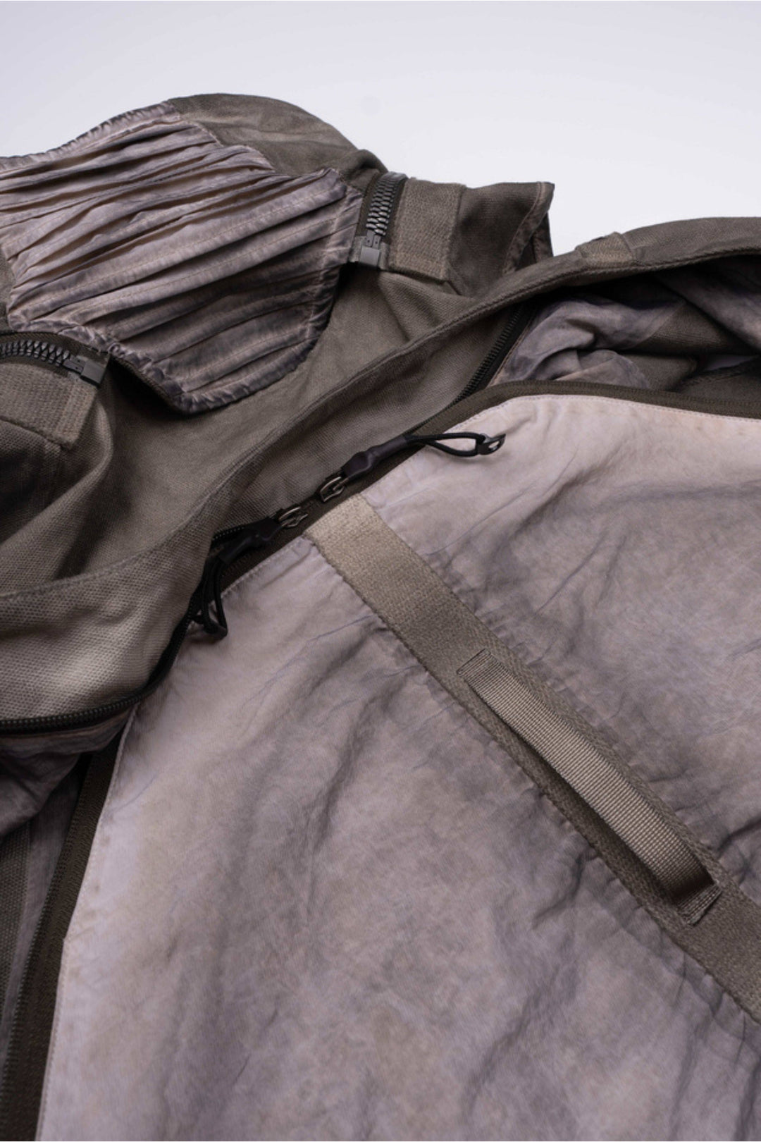 FISSION modular vest in mercury brown — close-up of the detachable collar and rear pouch zipper