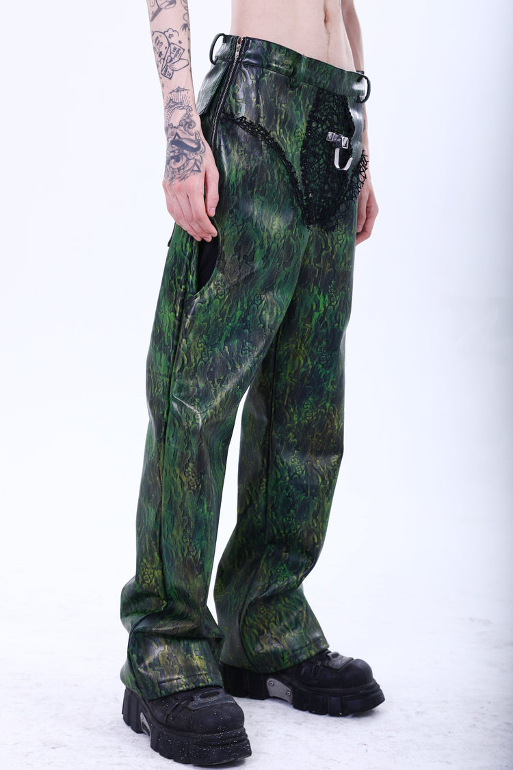EMBRYO TRIANGLE ARMOR lace-inset leather pants in green — full-length three-quarter front modeled view showing the hip zipper
