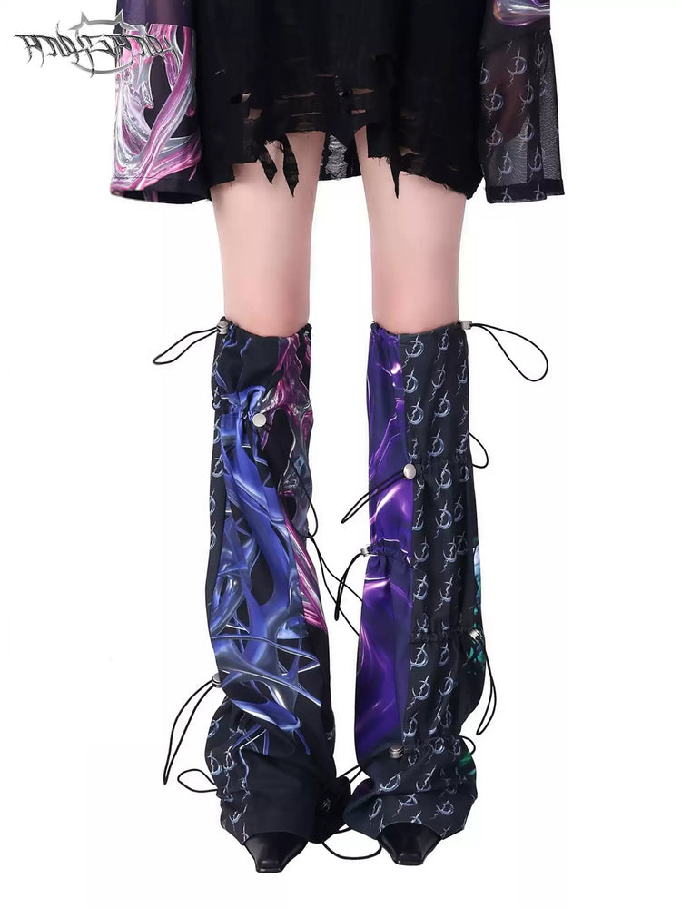 PINKSPINK COSMOS drawcord patchwork leg warmers in black purple multicolor — modeled close-up showing the mixed graphic panels and drawcords