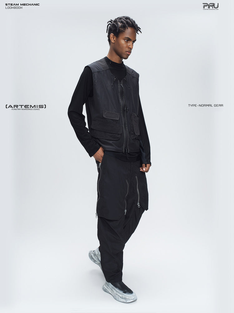 CLERIC utility nylon vest in stardust black — full-length modeled view with one hand in a trouser pocket