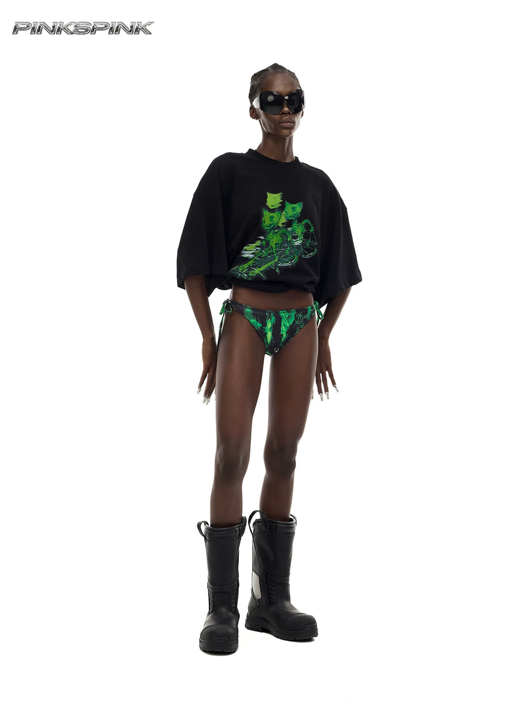 PINKSPINK MONSTER cat-skeleton oversized graphic tee in black — angled full-length modeled view with the hem rolled up for styling