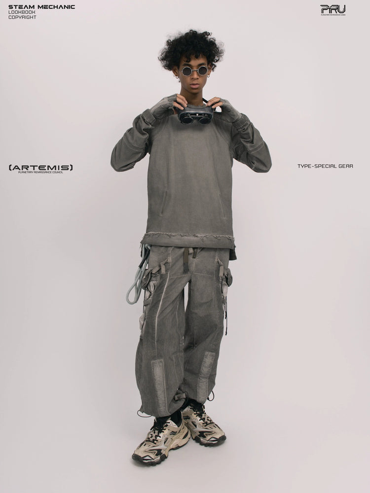 CHAOS ERA moon dust gray raw-edge long-sleeve top — full-length front view adjusting the goggles