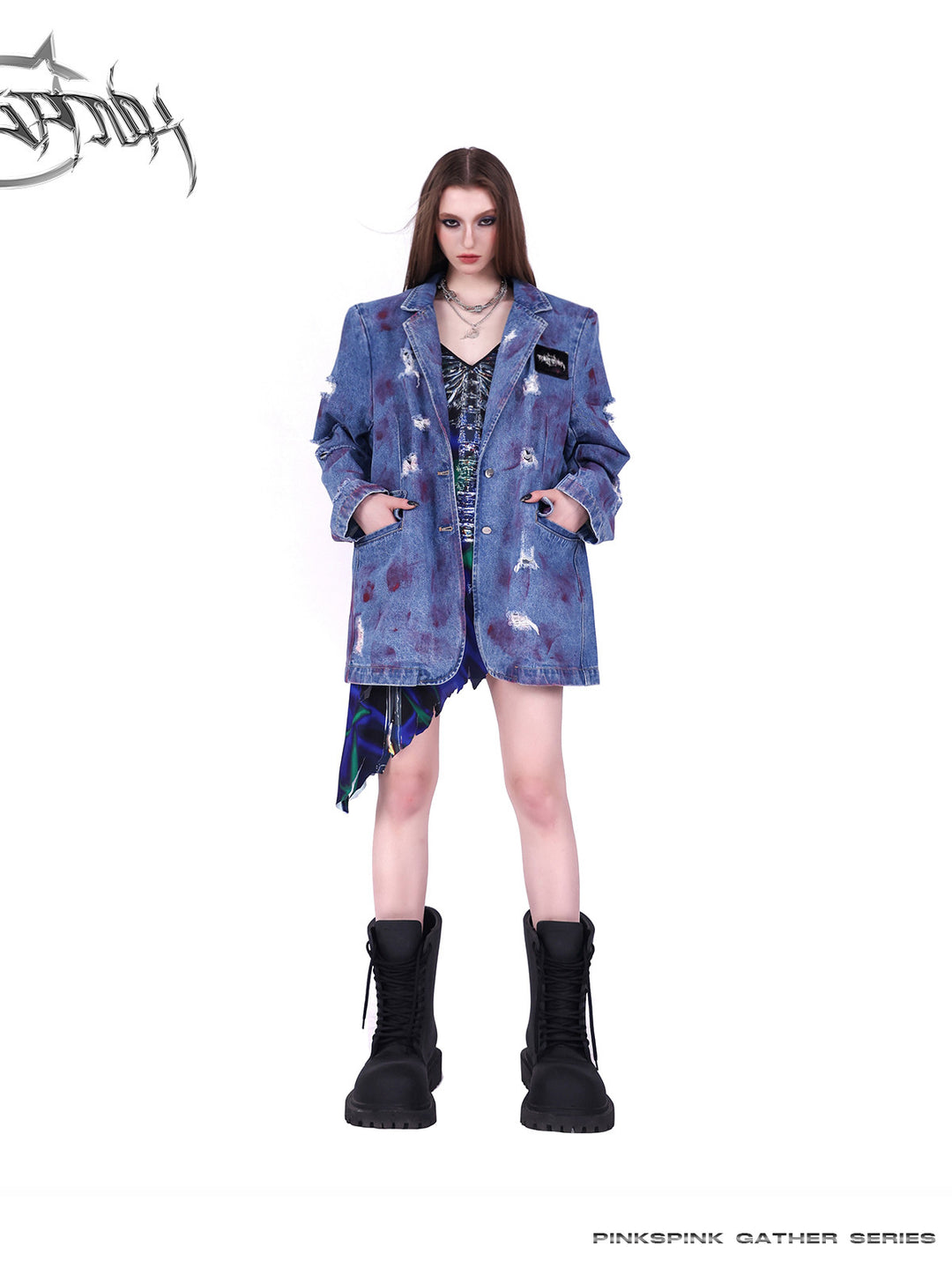 PINKSPINK COSMOS skeleton-print asymmetric slip dress in blue green multicolor — front modeled view with hands in the styling jacket pockets