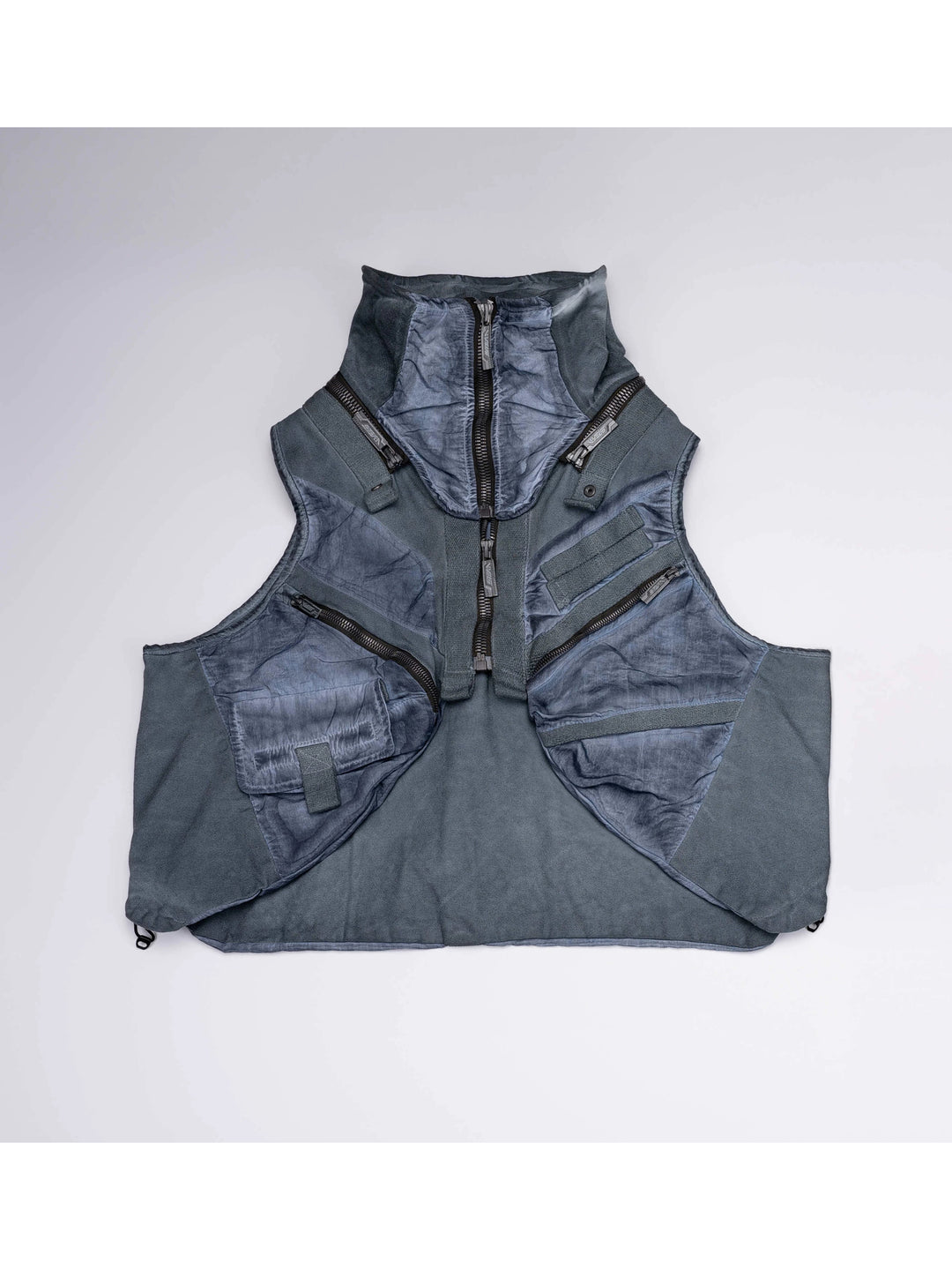 FISSION modular vest in star blue — blue front garment-only view showing raised collar, zip pockets and modular panels