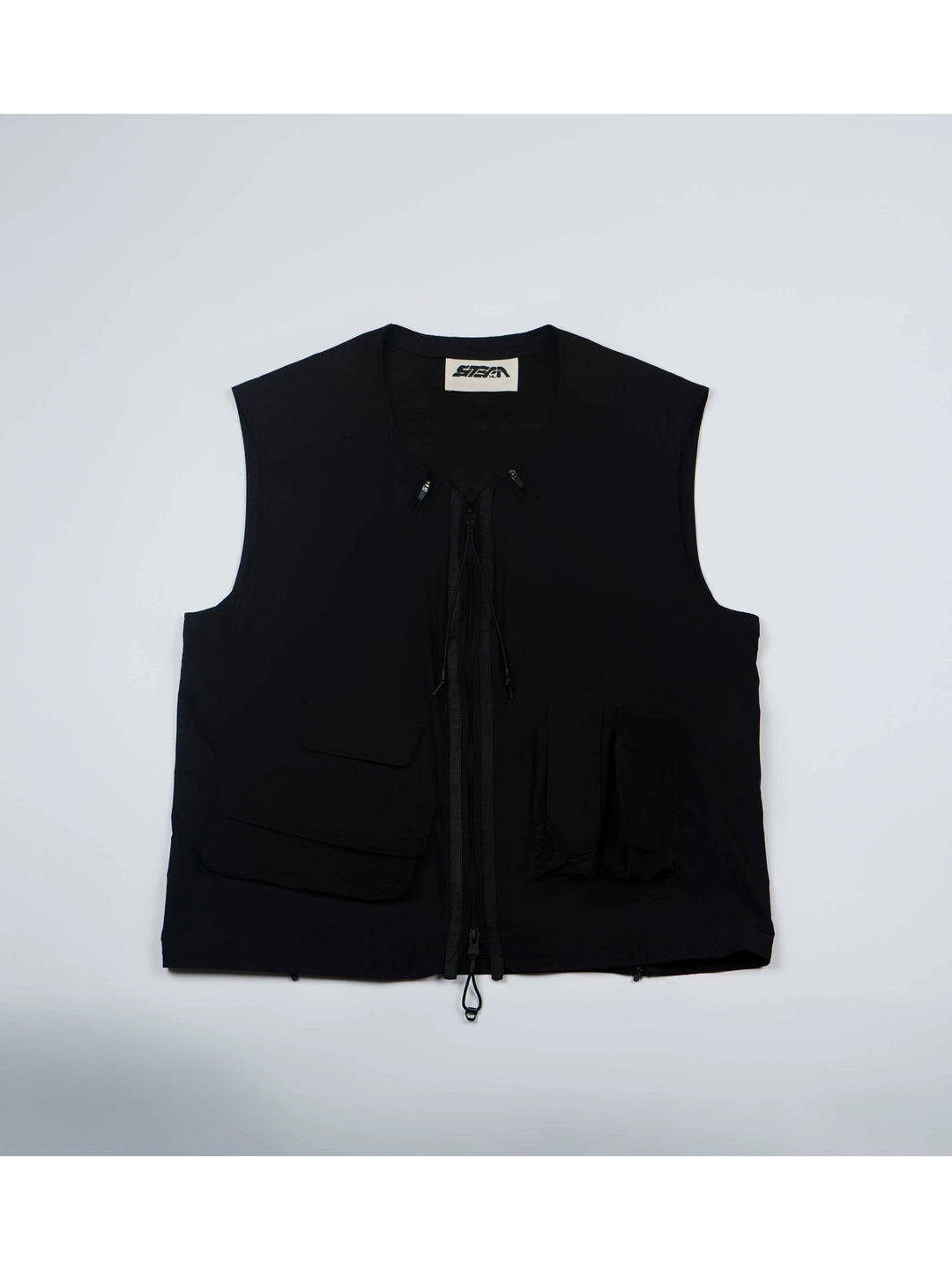 CLERIC utility nylon vest in stardust black — front flat-lay showing the asymmetric pockets and double-ended zip